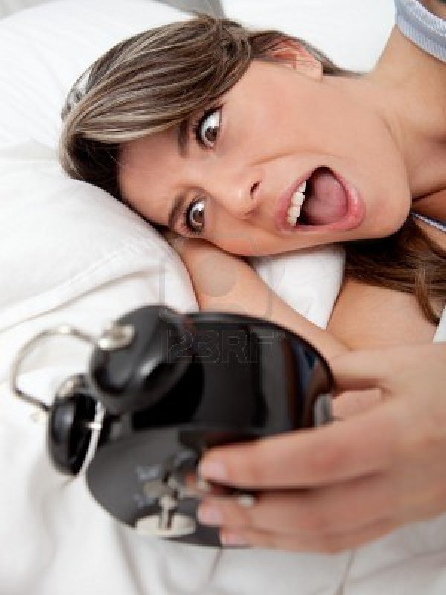 10957063-woman-waking-up-and-running-late-looking-at-the-alarm-clock